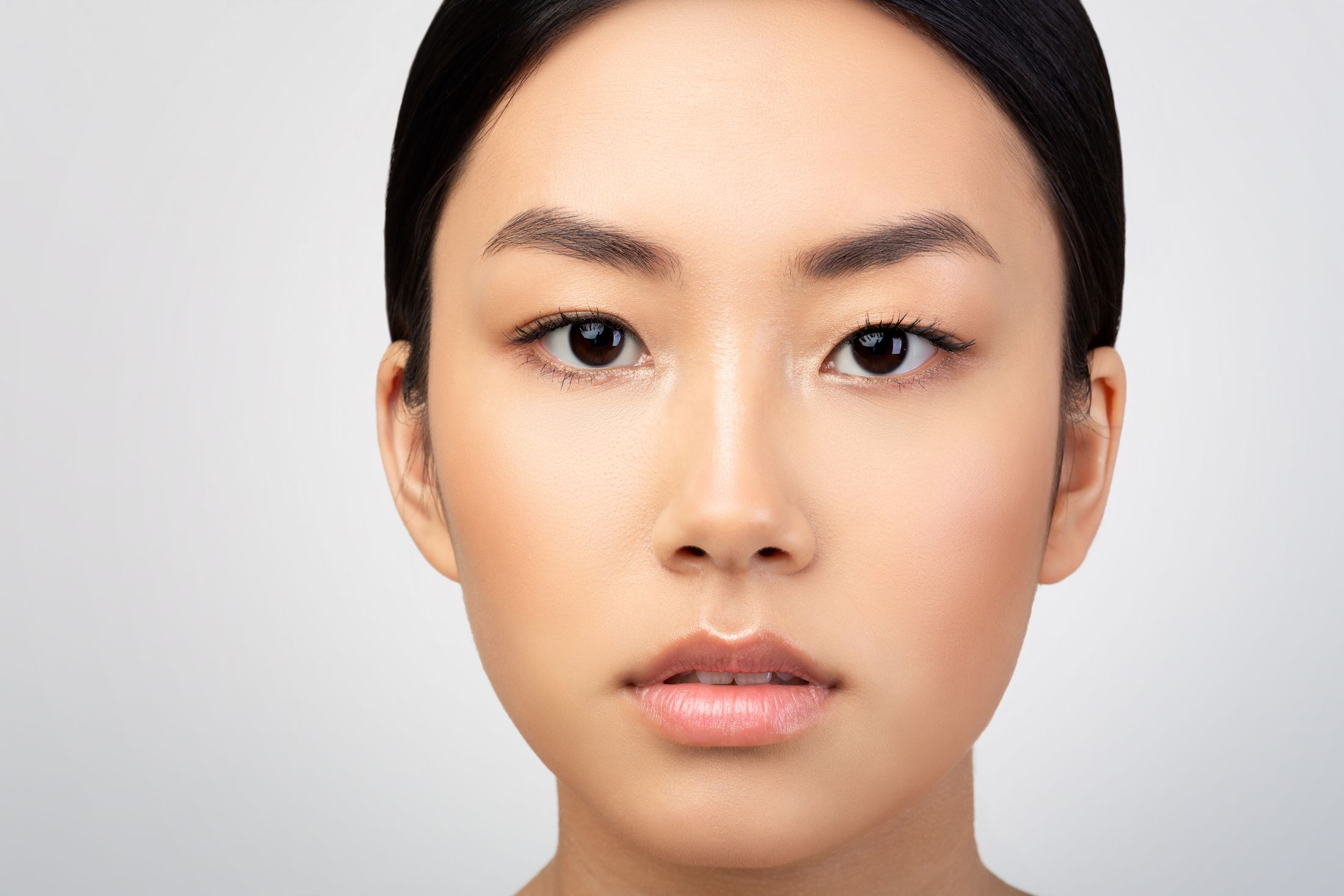 Portrait of a woman with a neutral expression.