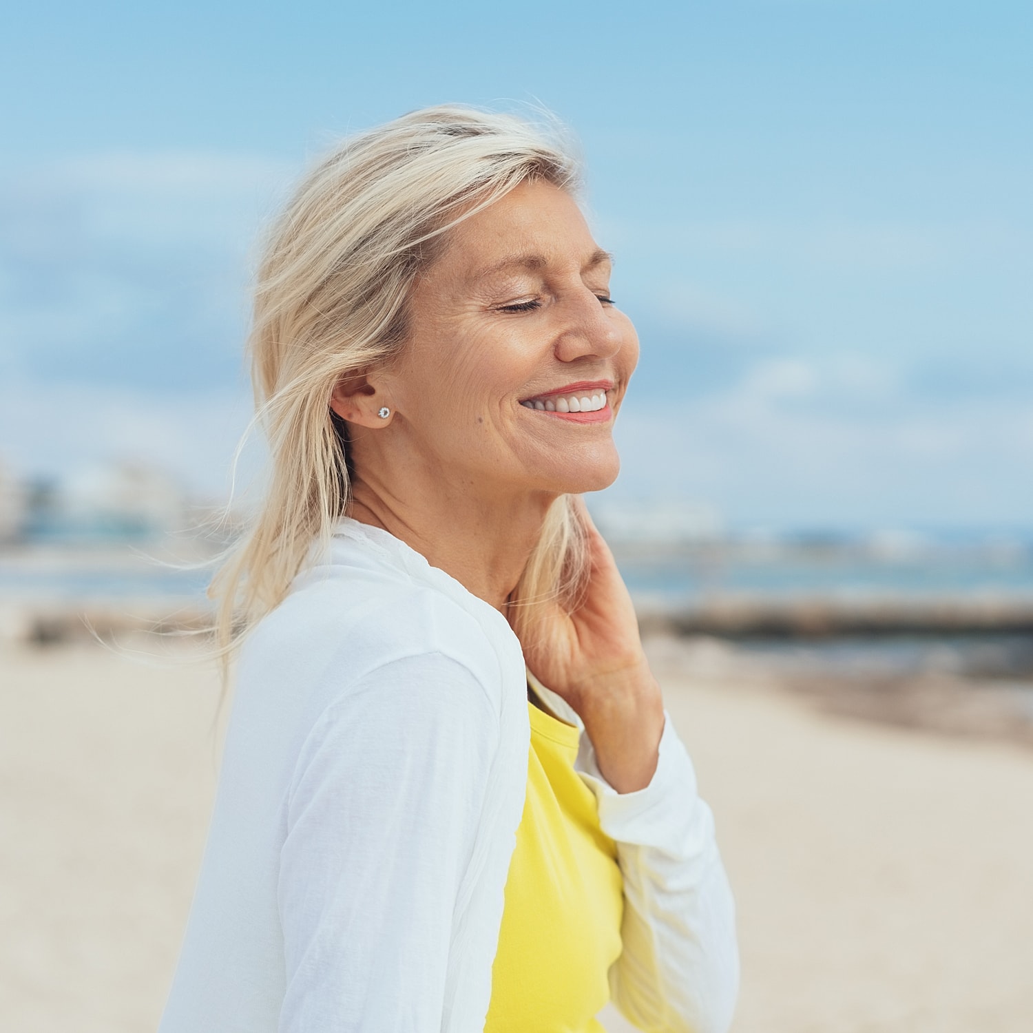 Smiling woman enjoying a beach day.