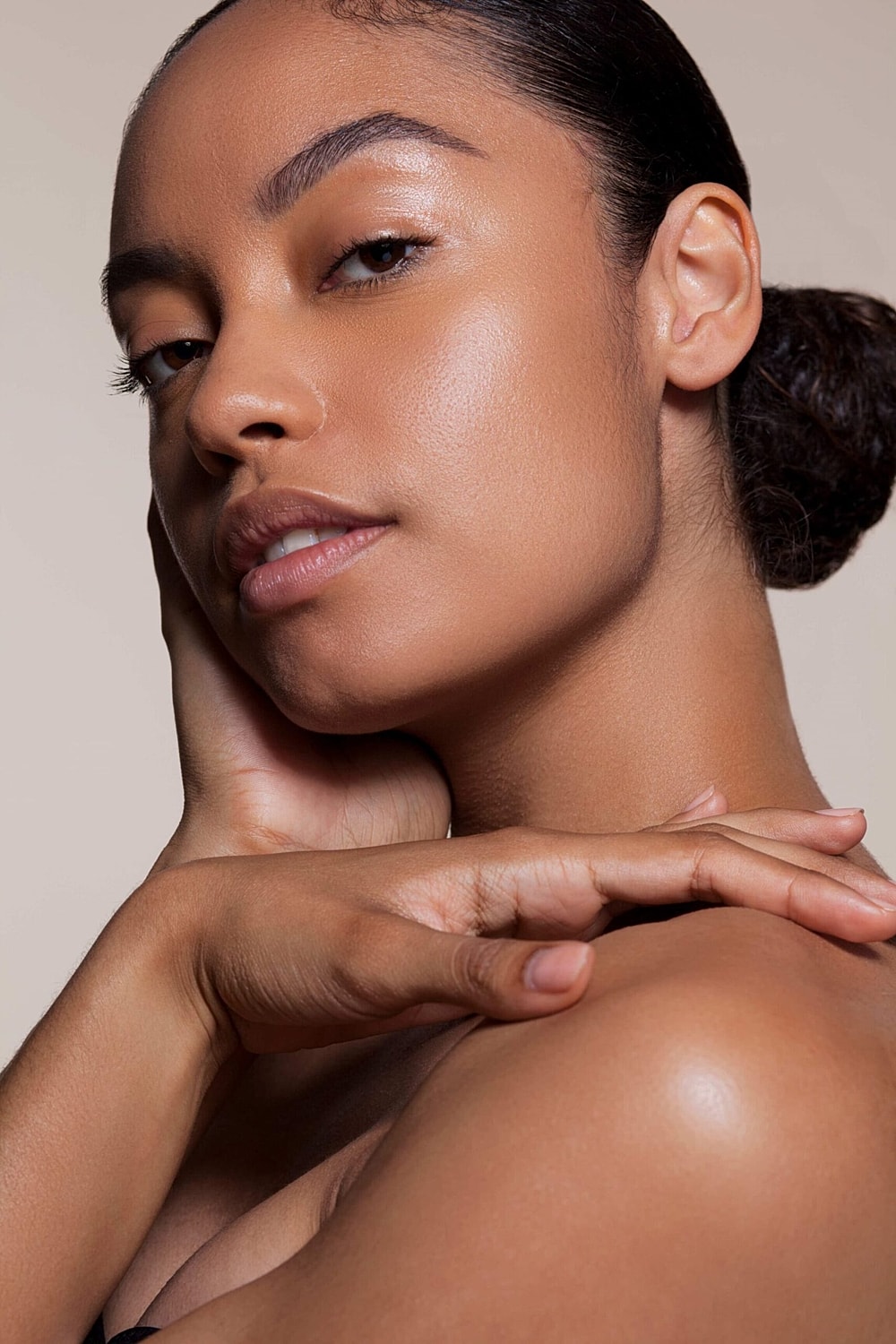 Close-up portrait of a woman with radiant skin.