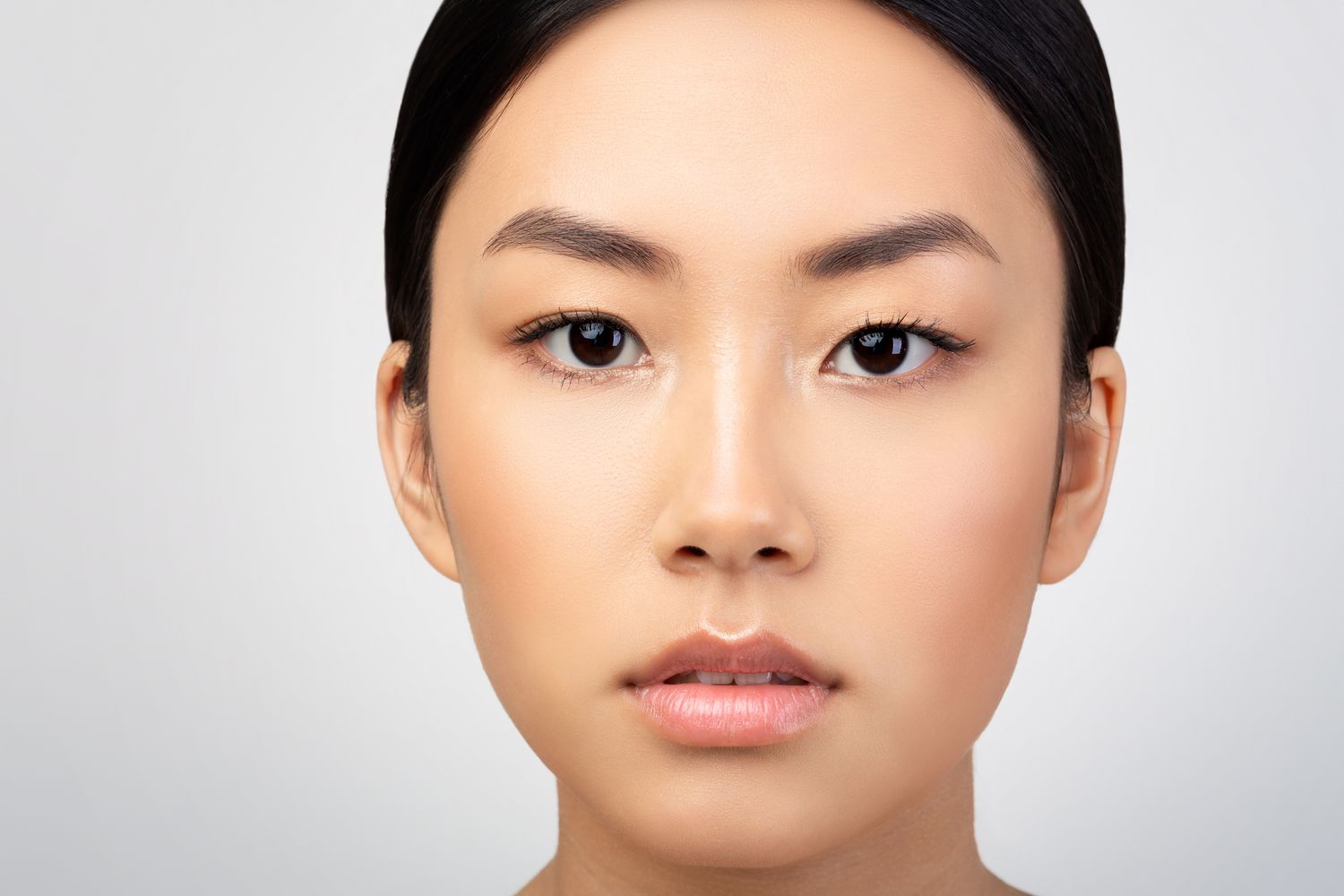 Close-up of a woman’s face with neutral expression.