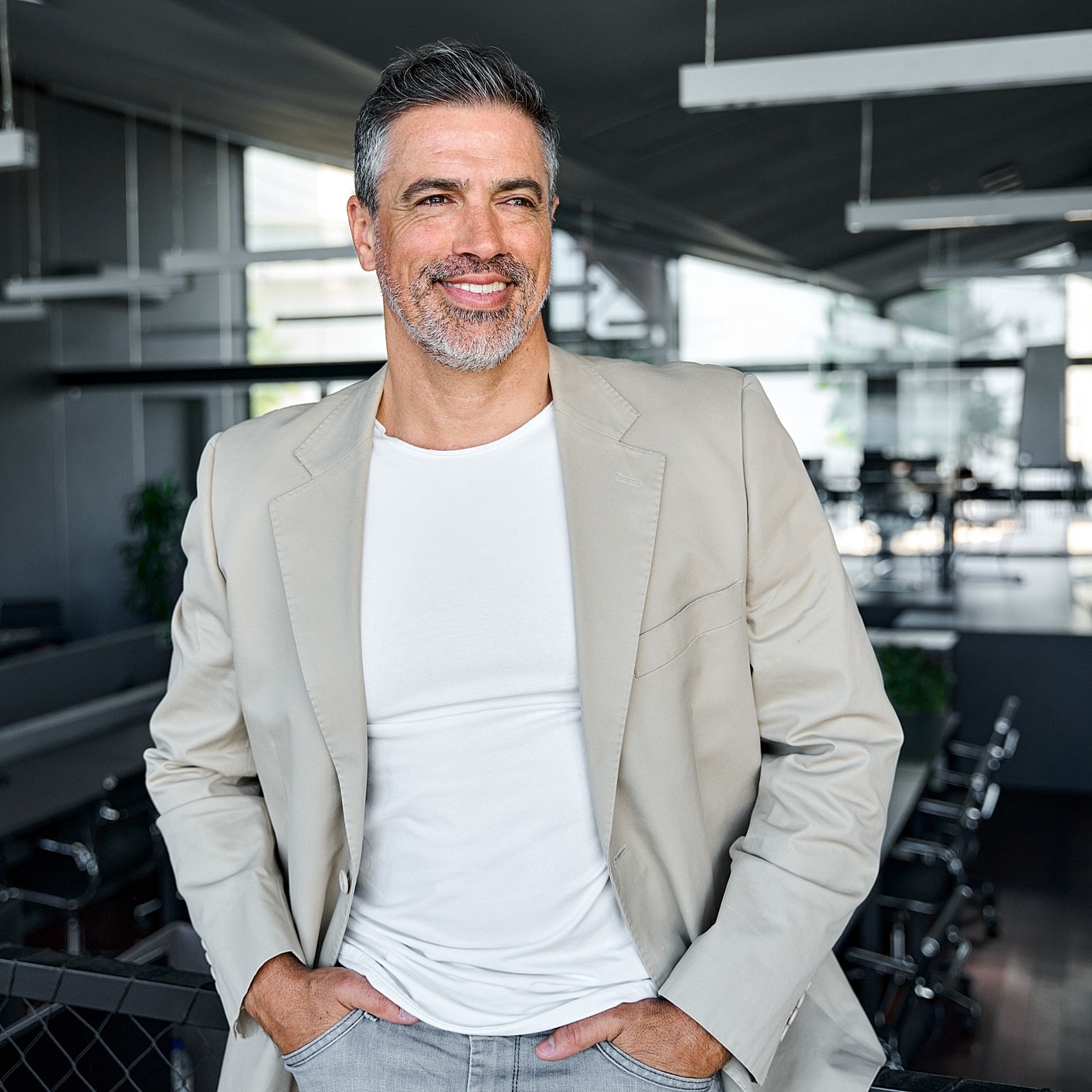 Smiling man in a stylish office setting.