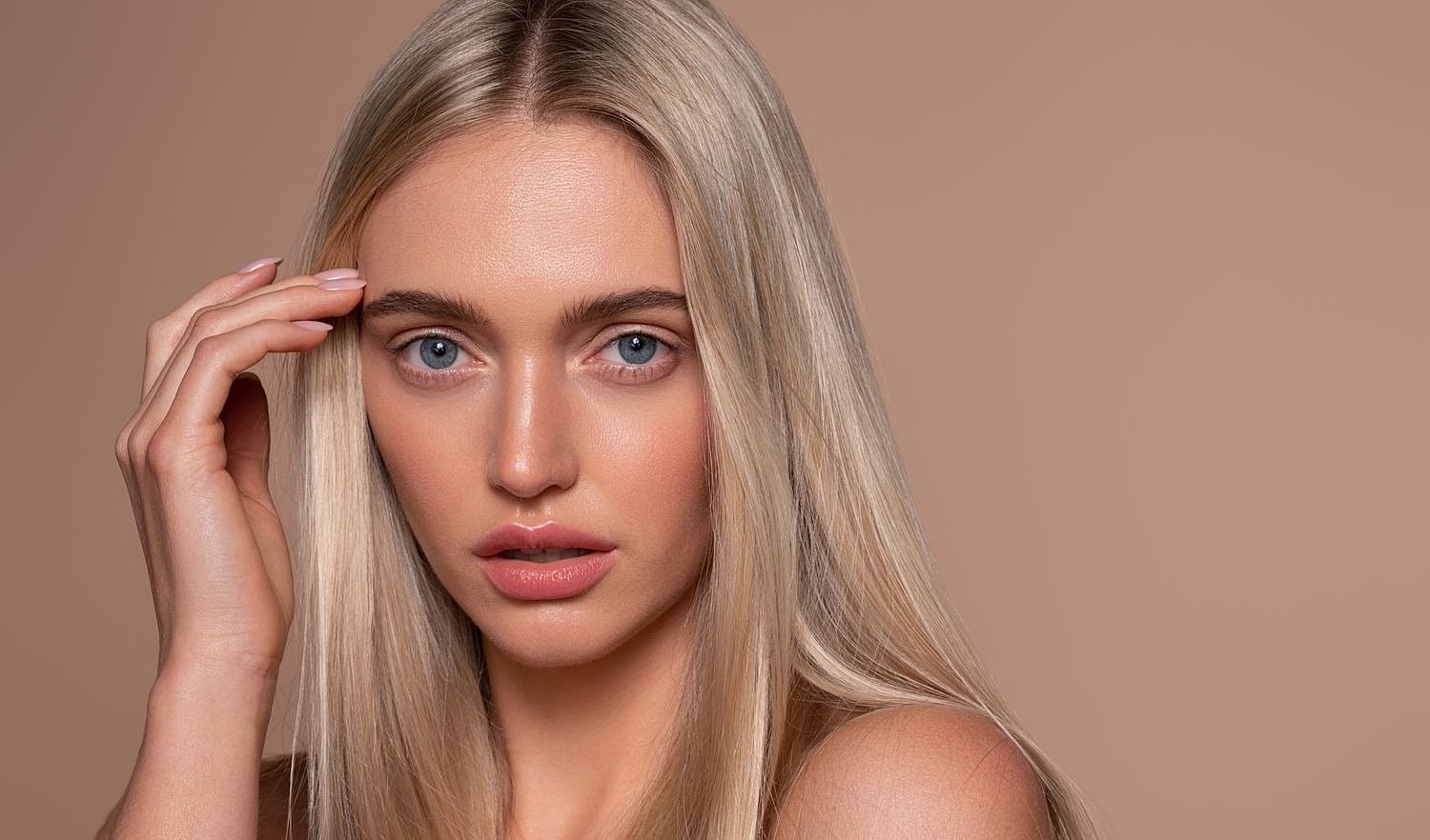 Close-up portrait of a woman with blonde hair.