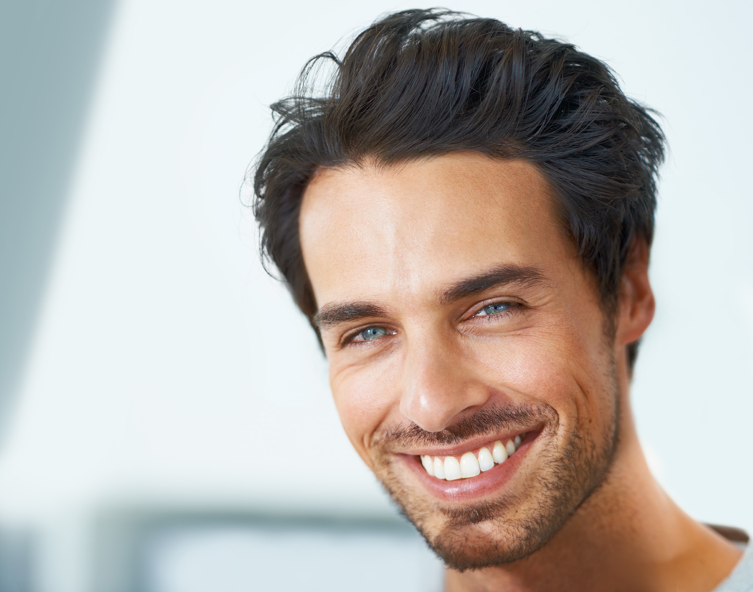 Smiling man with short dark hair and beard.