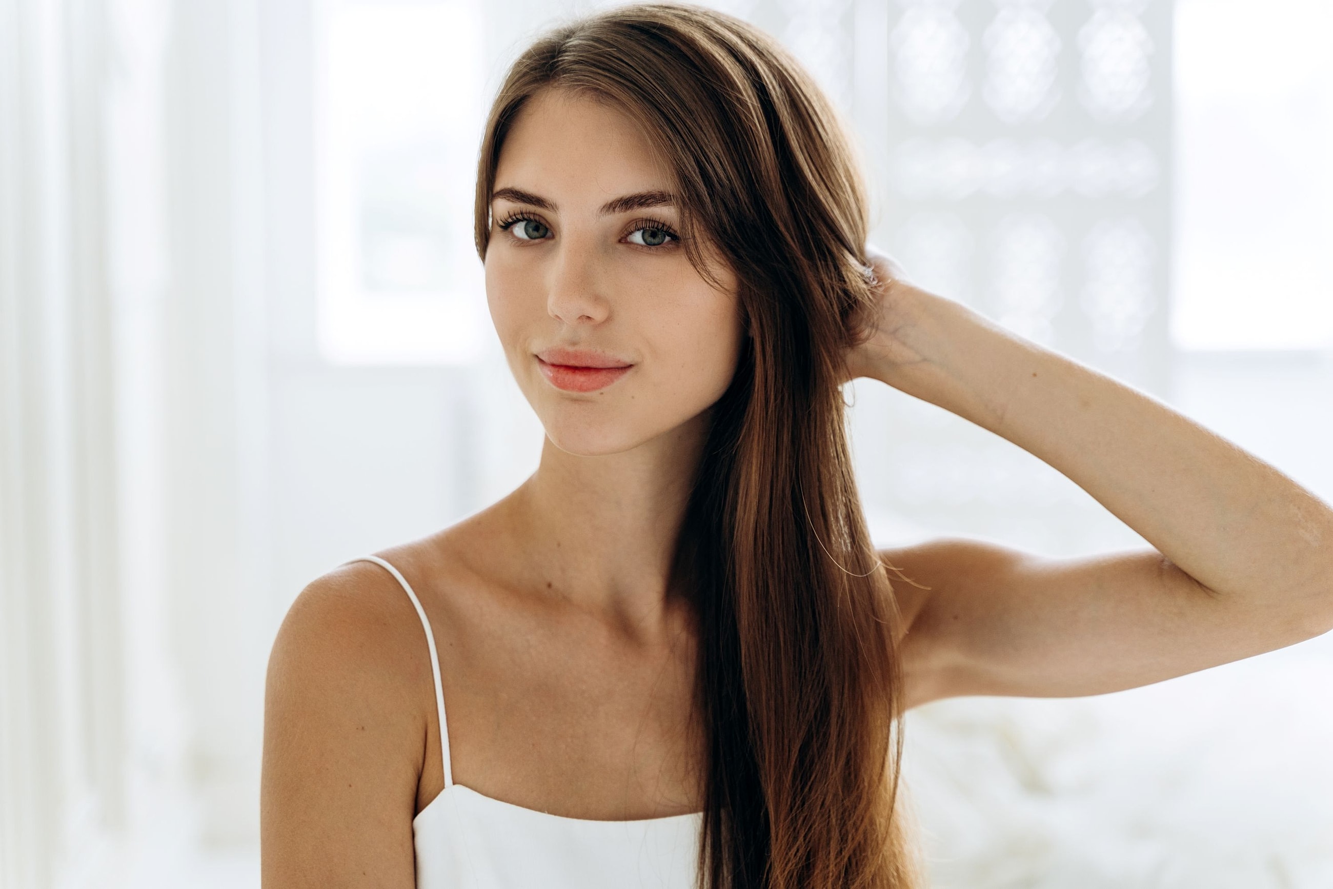 Woman with smooth, youthful-looking skin representing facial rejuvenation treatment options, including non-surgical and surgical approaches.