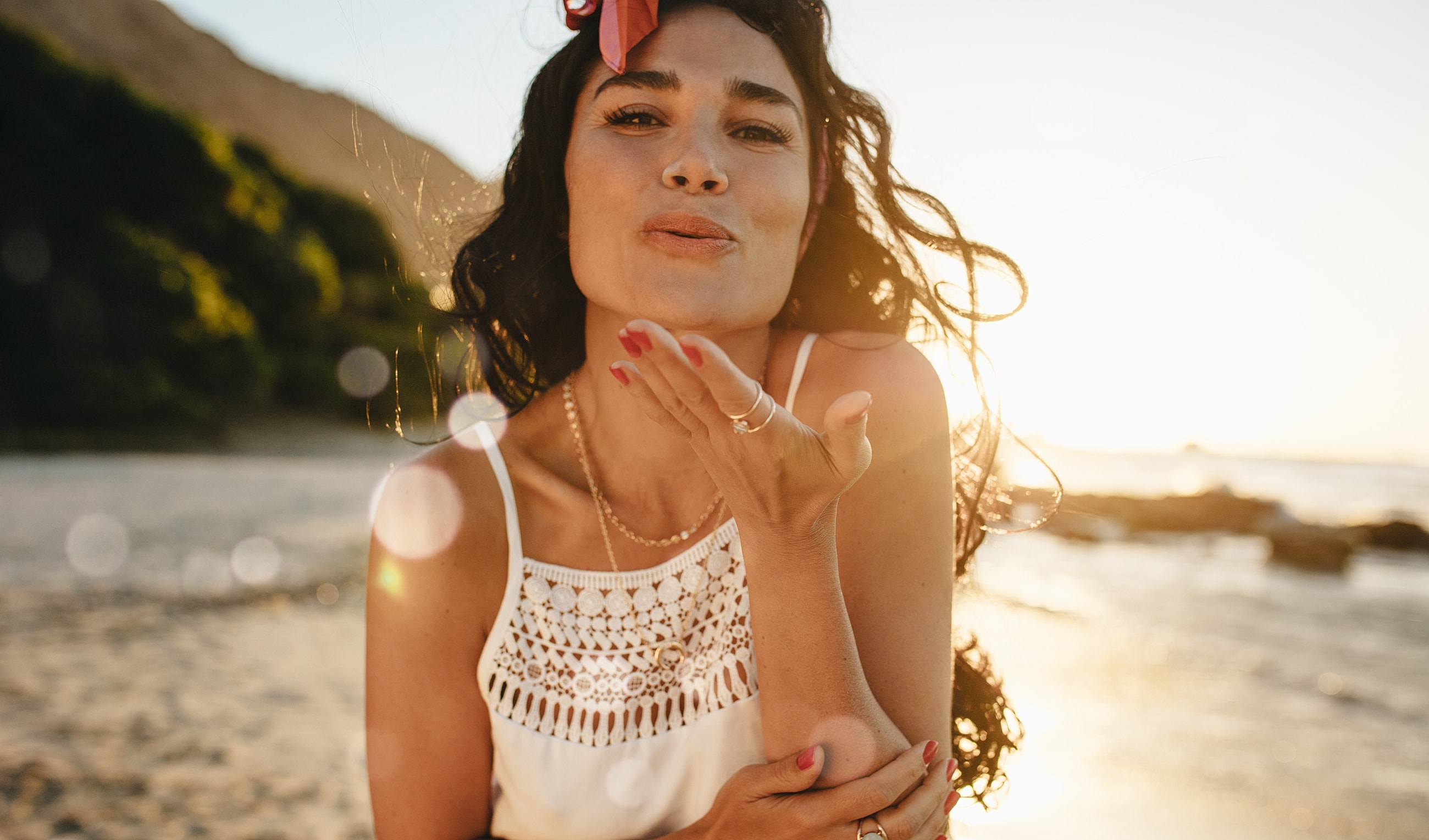 A woman showing natural facial rejuvenation results after a facelift in Newport Beach.